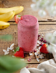 Strawberry smoothie on a rustic table. Healthy drink.