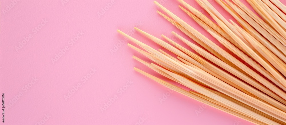 Poster toothpicks made of wood placed on a pink backdrop with copy space image.