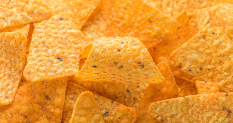 Pile of corn tortilla chips or nachos background
