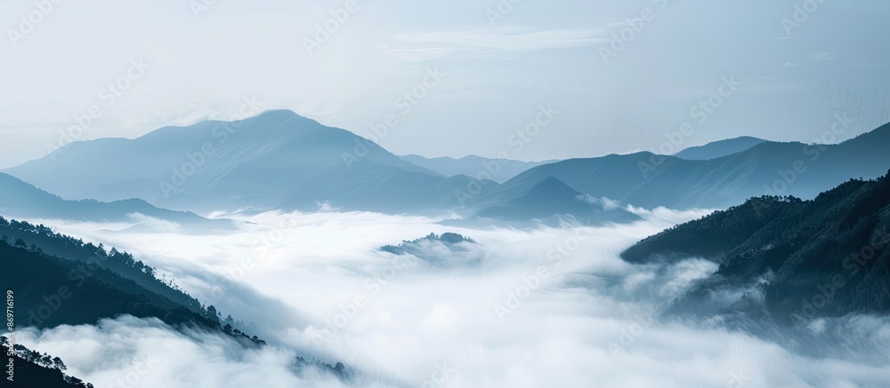 Poster mountain landscape with copy space image featuring drifting low clouds.