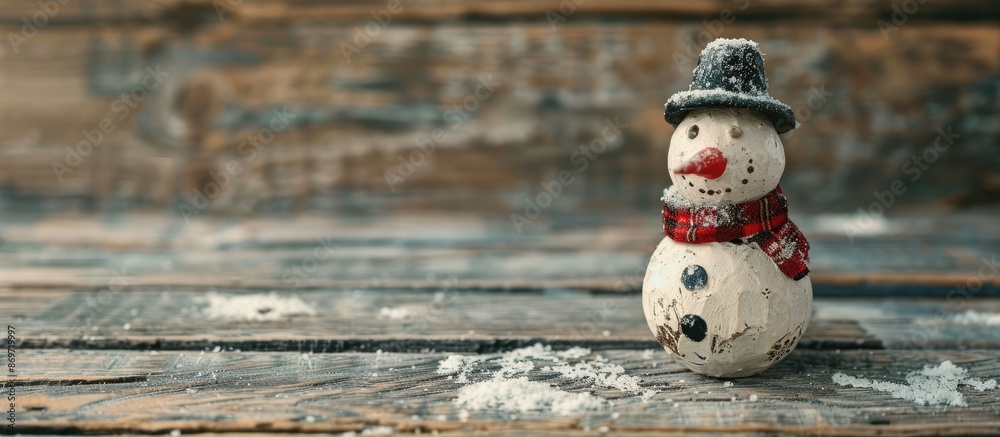 Poster Horizontal photo of a snowman on a rustic wooden board for Christmas background with copy space image.