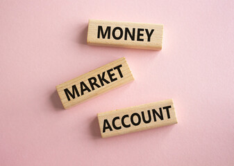 Money Market Account symbol. Wooden blocks with words Money Market Account. Beautiful pink background. Business and Money Market Account concept. Copy space.