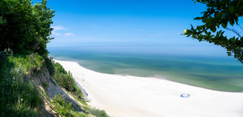 view on sandy beach on Baltic sea in Poland during sunny day