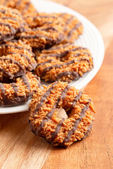 Sweet and Sticky Coconut Caramel Fudge Striped Cookies on a Wooden Table