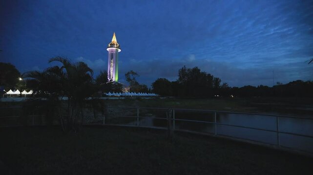 A natural video background from a high angle where you can see the colors of the beautiful evening sky, trees and lights from residences, the beauty of traveling with today's technology.