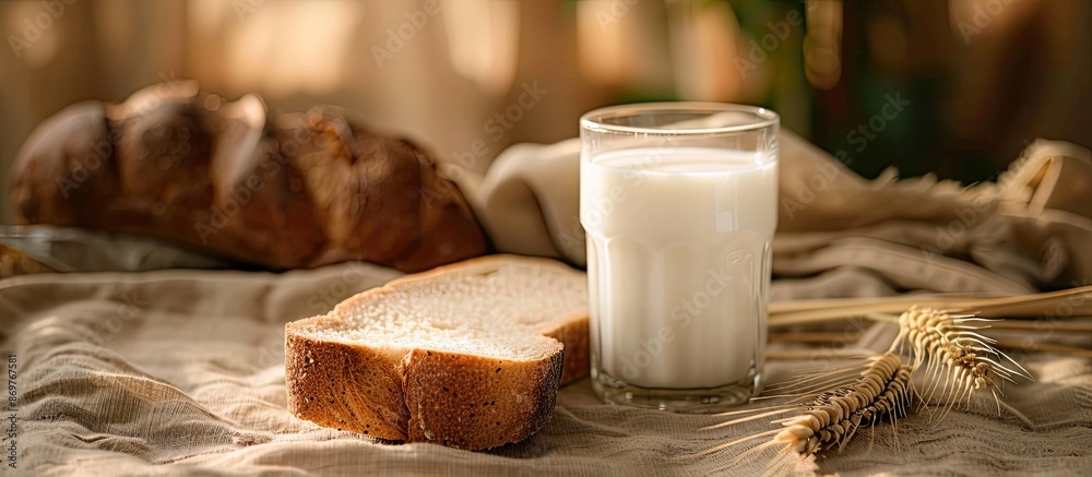 Poster A slice of bread and a glass of milk placed on a cloth-covered table with ample copy space image.