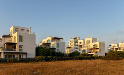 White beach house with sunny swimming pool