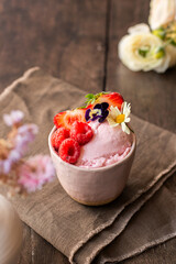 Homemade Strawberry ice cream, in a ceramic bowl on the table. Healthy summer dessert. Selective Focus