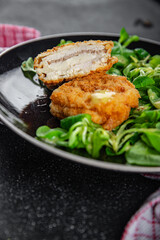 cutlet cordon bleu chicken meat, ham, cheese natural fresh appetizer meal food snack on the table copy space food background rustic top view