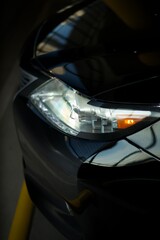 car headlights close-up.
The front of the car.
Car headlights on