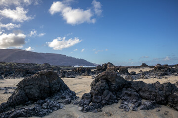 Beach with white sand and lava rocks, Lanzarote