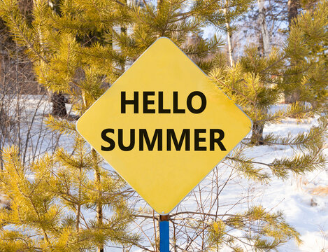 Hello summer symbol. Concept words Hello summer on beautiful yellow road sign. Beautiful forest trees snow background. Business lifestyle Hello summer concept. Copy space.
