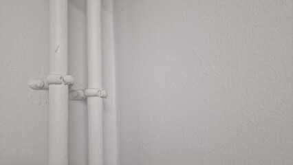 Heating pipes covered with white paint in a house