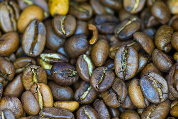Close-up shot of numerous roasted coffee beans,