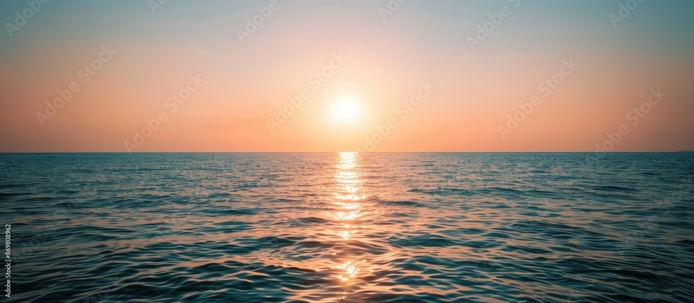 Poster Sun setting or rising over the sea or ocean, providing a scenic view with a copy space image.