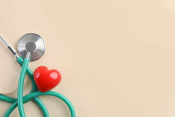Stethoscope and red heart on beige background, top view. Space for text