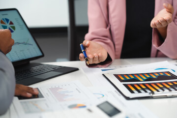 Business people analyzing financial documents with charts and graphs at the office