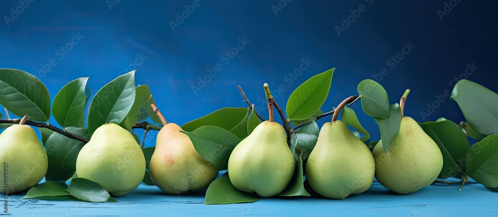 Poster fresh pears and leaves are set against a blue backdrop, ideal for a 