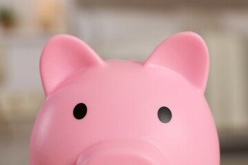 Pink piggy bank on blurred background, closeup