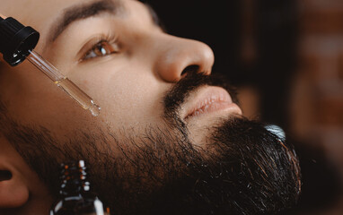 Spa cosmetic oil for hair of beard man and serum for skincare. Treatment wellness and natural...