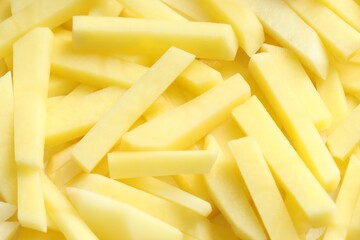 Cut fresh raw potatoes as background, closeup