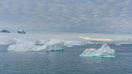 Antarctica Nature Background Landscape Icebergs Beautiful Wallpaper. Frozen Snow and Ice Distance Mountains. Climate Change Global Warming Scenic