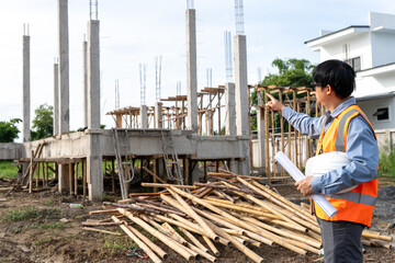 A team of construction engineers talks with managers and construction workers at the construction site. Quality inspection, plans, home and industrial building design projects