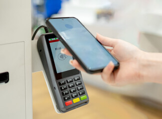 Girl Pays For Purchases At Self-Service Checkout Terminal, Close-Up Of Hands