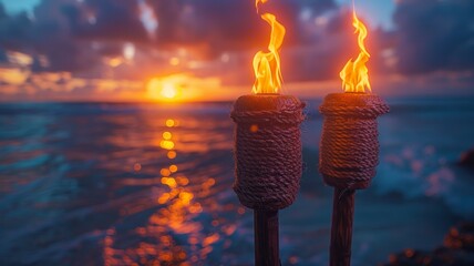 Two Tiki Torches with Bright Flames Set Against a Stunning Oceanview Sunset with Vibrant Colors and Dramatic Sky Over the WaterTiki torch