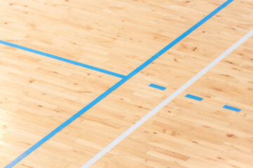 Wooden floor basketball, badminton, futsal, handball, volleyball, football, soccer court. Wooden floor of sports hall with marking lines on wooden floor indoor, gym court