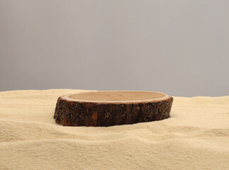 Wooden stump circle platform podium on beige sand background. Minimal empty display product...