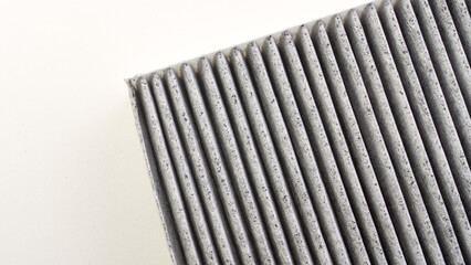 Carbon fabric filter of a car air conditioner on a white background from different angles in close-up. The concept of clean air in the car interior and cleaning the car ventilation system.