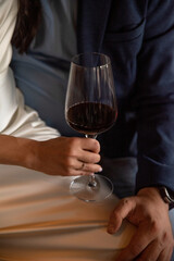 Woman's hand holding a glass of red wine close-up