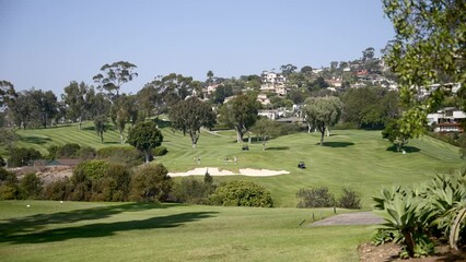 Country Club golf course with blue sky overlooking the Pacific Ocean and city of La Jolla in California during a sunny day