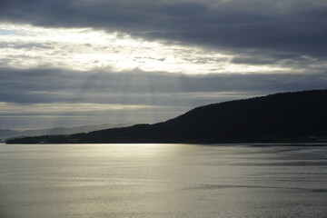 Summer in the fjords of Norway. A bright sunset and cirrus clouds illuminated by the setting sun. HDR light