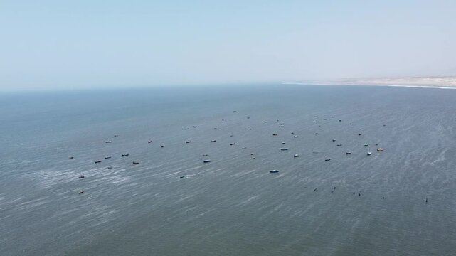 Ocean view in Pacasmayo beach, Peru. Many sailboats in one place, a view from a height