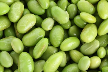 Raw green edamame soybeans as background, top view
