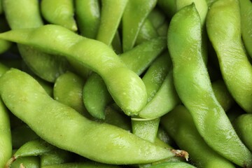 Fresh edamame pods as background, above view