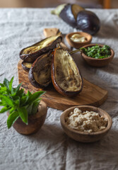Ingridients for Jewish eggplant baba ganoush on wooden board.