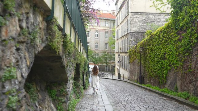 Paris, France. A girl walks along the Rue Montmartre