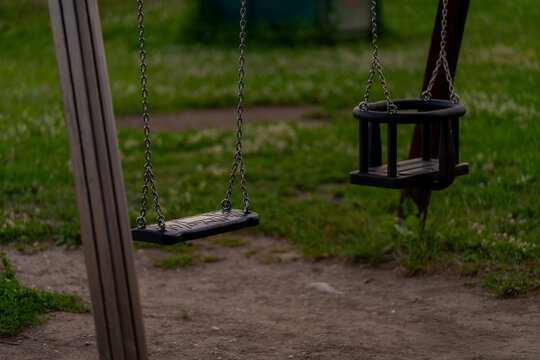 Sad empty children swings with nobody in the playground