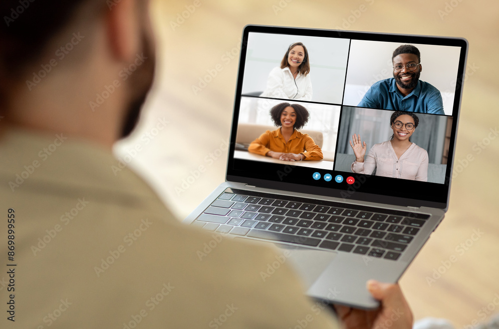 Aufkleber unrecognizable man attending a video conference meeting on a laptop. the laptop screen displays four