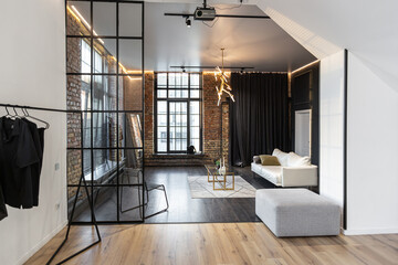 minimalistic stylish interior of luxury apartment with white stylish bedroom and dark living room....