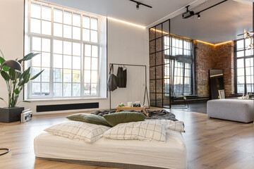 minimalist stylish interior of white simple bedroom with window in ceiling and sun rays without people