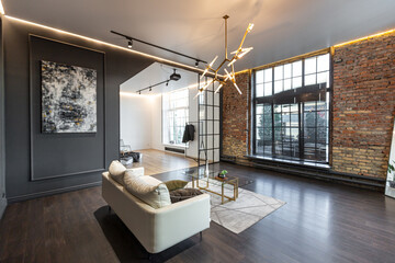 minimalistic stylish interior of luxury apartment with white stylish bedroom and dark living room. modern apartments with an open layout during the day without people and amazing sun rays