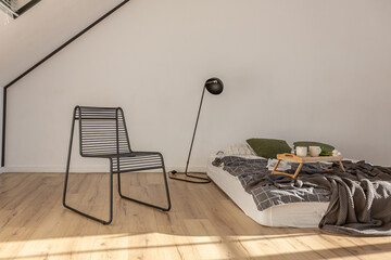 minimalist stylish interior of white simple bedroom with window in ceiling and sun rays without...