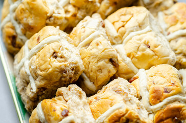 A tray of pastries with a white cross on top