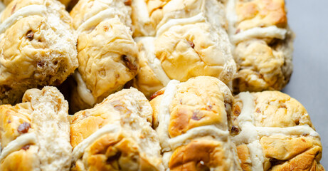 A tray of pastries with a white cross on top
