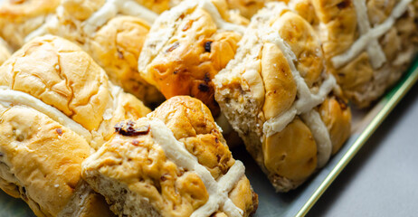 A tray of pastries with a white cross on top