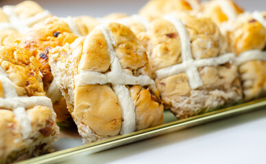 A tray of pastries with a white cross on top